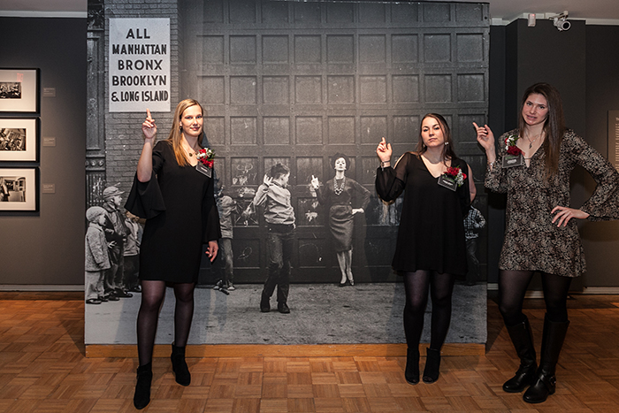 The student-curators pose with Lida Moser's famous 1961 photograph, “Mimicry (Judy and the Boys),” Photo by Carl Socolow '77.