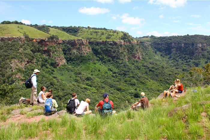 students contemplate the valley of a thousand hills