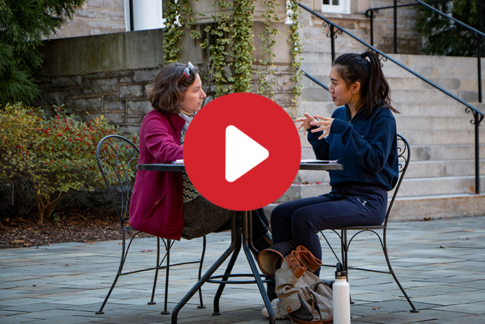 Professor of music Amy Wlodarski works with a student in front of Weiss.