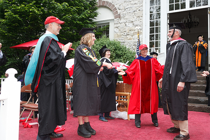 Moments after receiving her own Dickinson College degree, Anna Wagman, class of 2016, helped award a diploma to her father, Joseph Wagman.