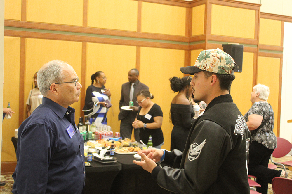 An A.C.E. Peer Mentor engaging in a conversation with a community member