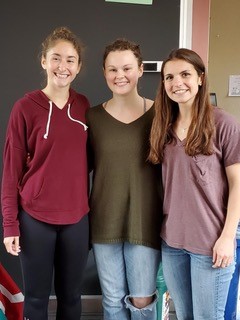 three students at a conference