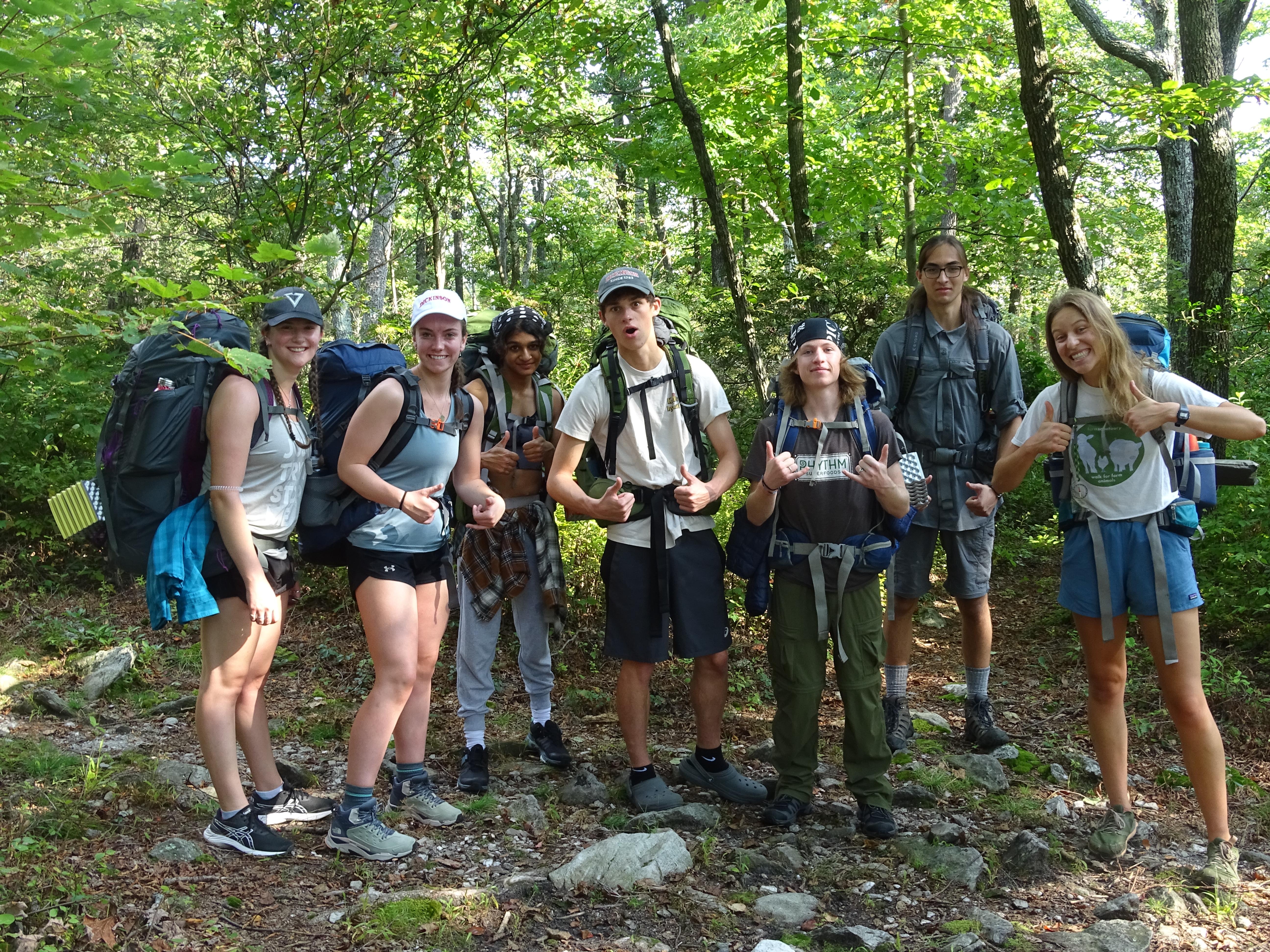 Students pause while backpacking 