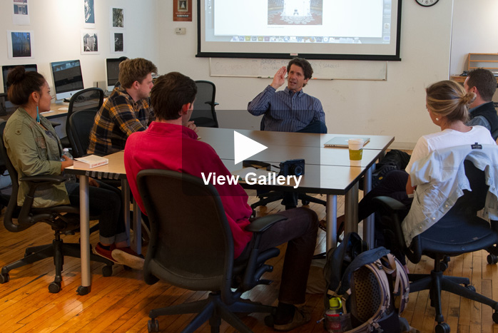 A photo of James Balog talking in students in class with 