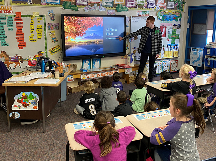Ben Norris '23 gives a presentation at a private elementary school where he worked in an after-school program last year.