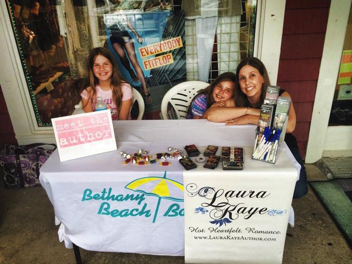 laura kamoie with her kids at a book signing event