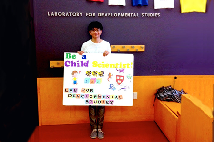 Cai Guo '16 poses in Harvard University's Laboratory for Developmental Studies, where he interned in summer, 2014.