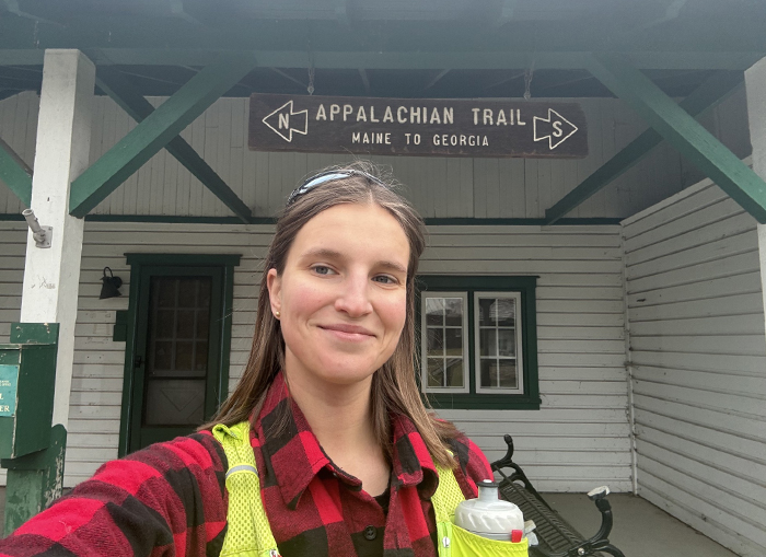 a young woman smiles and takes a selfie along the Appalachian Trail