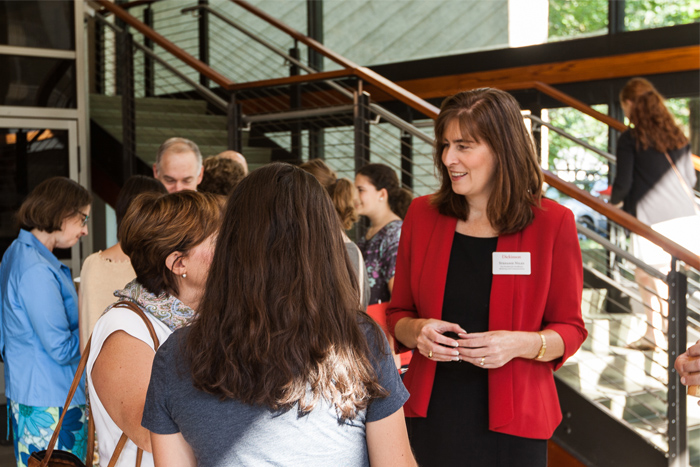 Stefanie Niles, vice president for enrollment, marketing & communications, greets families before the open house. Photo by Nick Bailey '16.