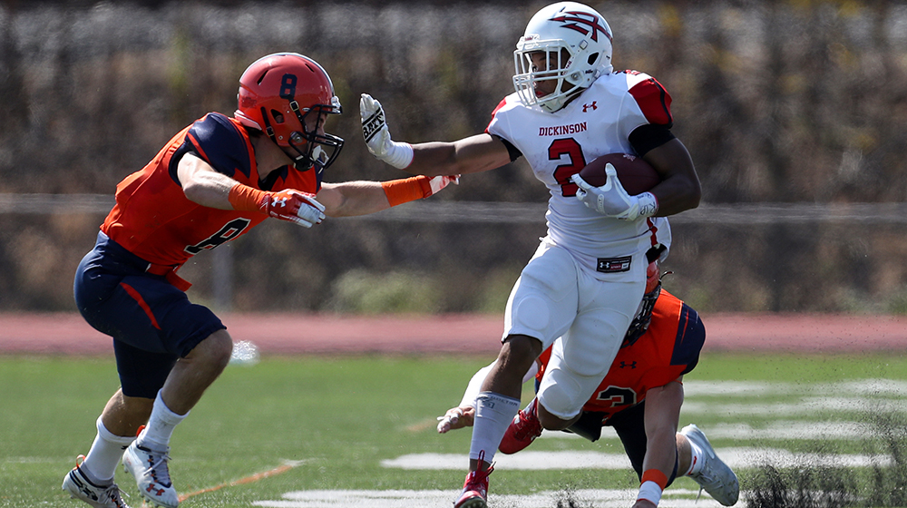 A running back breaks through the line