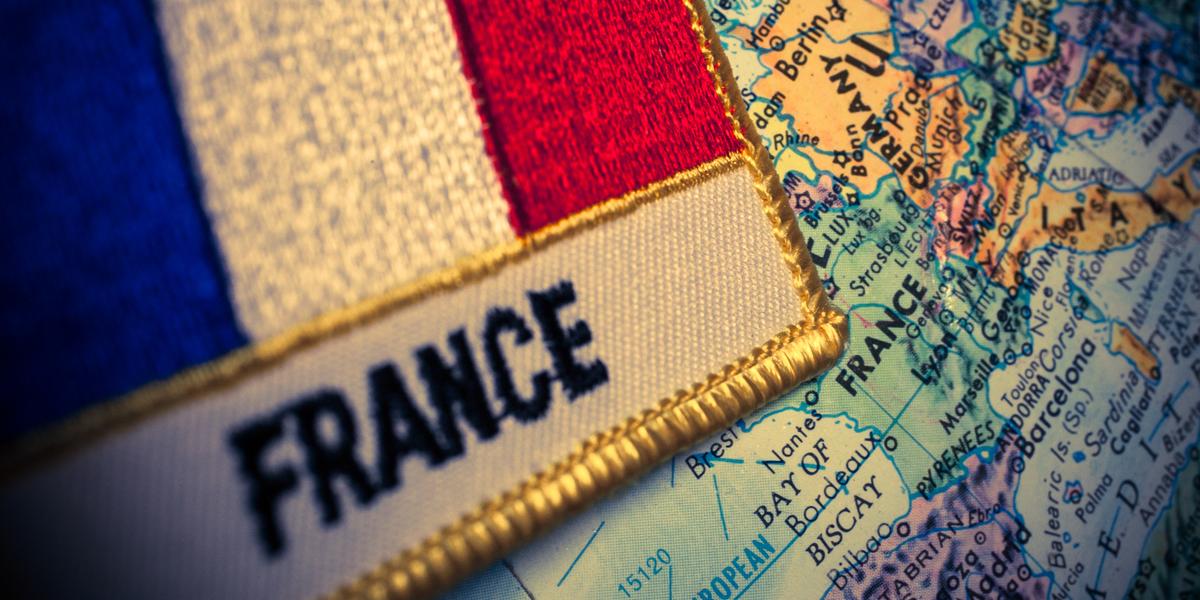 A France patch resting on a globe.