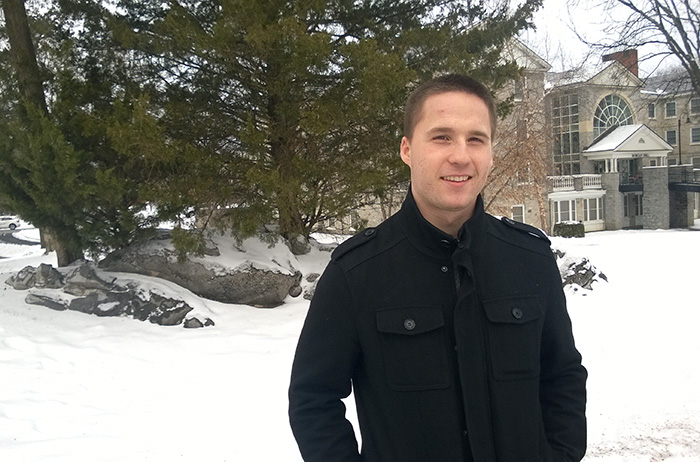 Chris Fritz '17 poses in front of Old West.