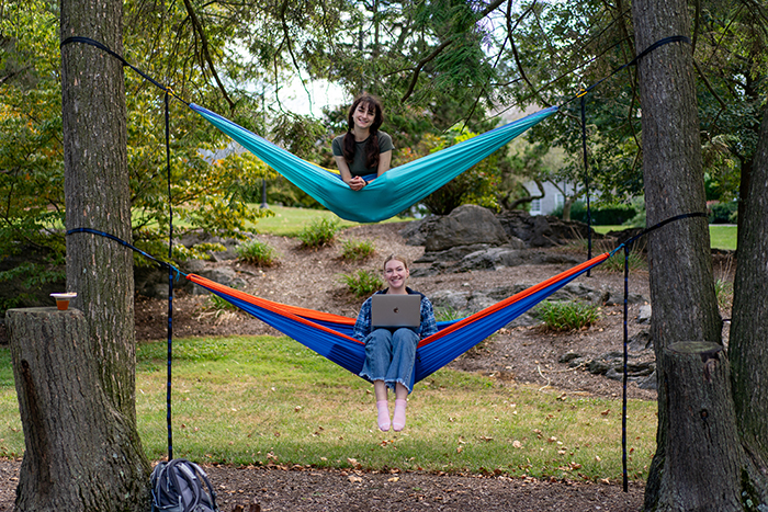 Two Students relax in hammocks in Morgan Field