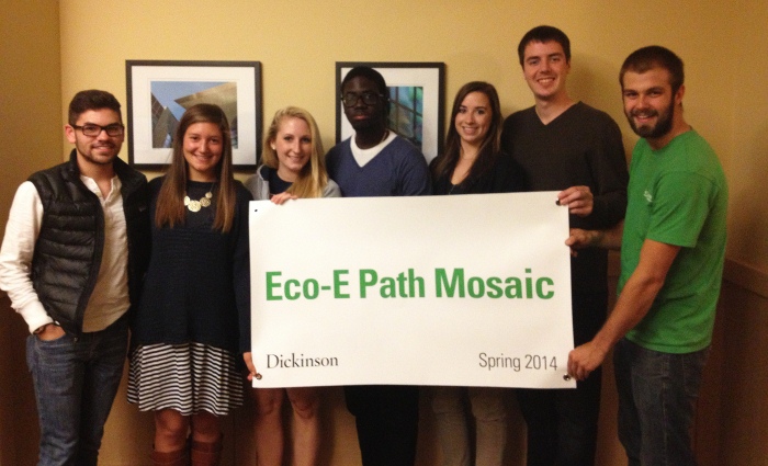 Students pose with mosaic signage