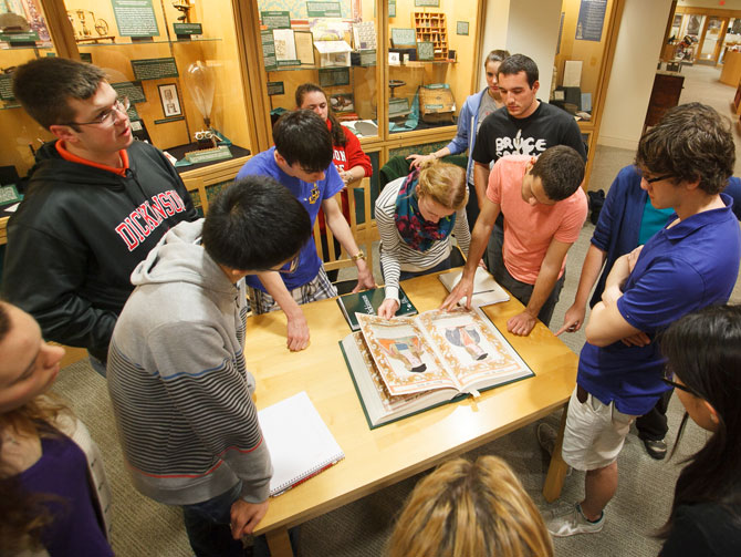 Students looking at a manuscript in the Dickinson archives.
