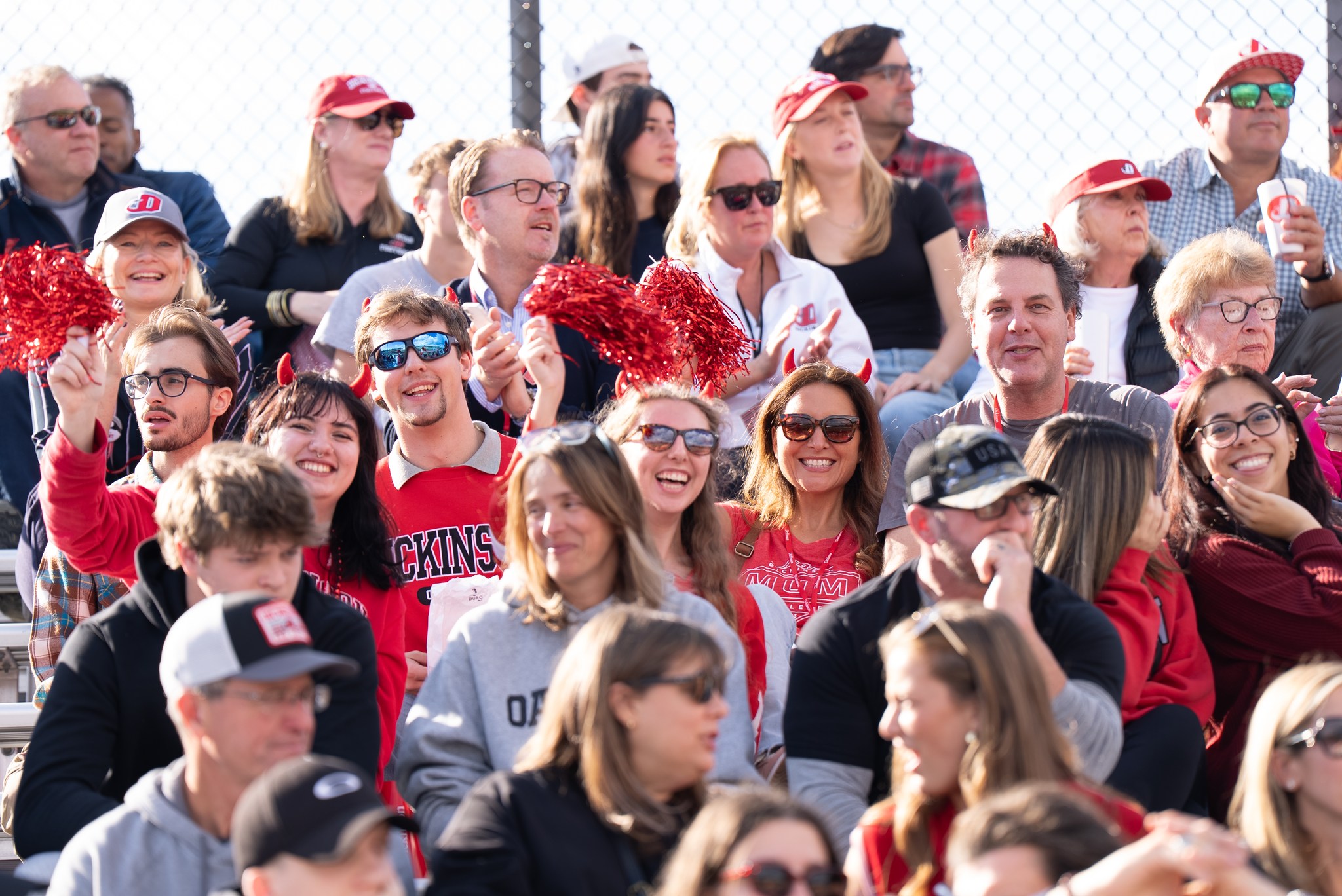 a crowd cheers on the red devils during the 2025 homecoming game.