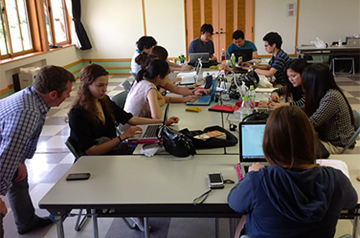 Dickinson and Akita International University students perform quantitative and qualitative data analysis at  the Nakahitane community center in Akita Prefecture, Japan. Photo by John Henson.