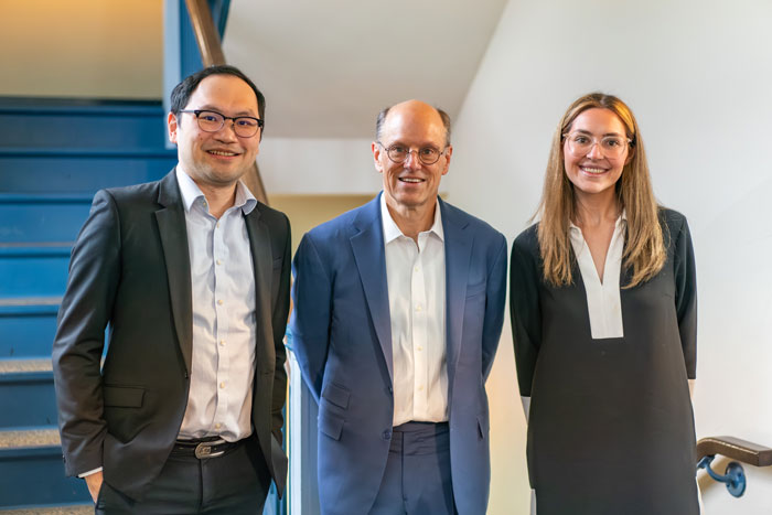 three alumni pose together