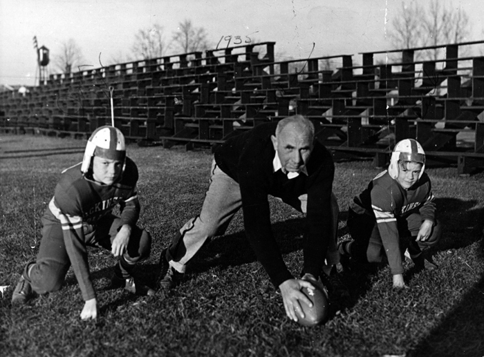 Richard McAndrews poses with the two sons of a fellow coach in 1935.