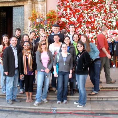 Málaga Director Mark Aldrich poses on steps with students