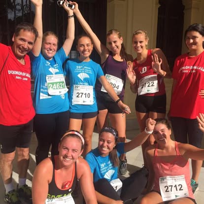 Málaga Director Mark Aldrich poses with students before a 5K run in Fall 2017