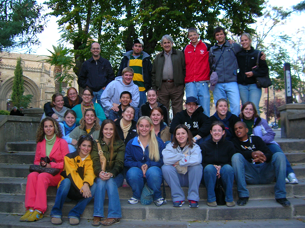 Malaga Director Marcelo Borges takes a group photo on stone steps outside with the Fall 2005 Malaga students