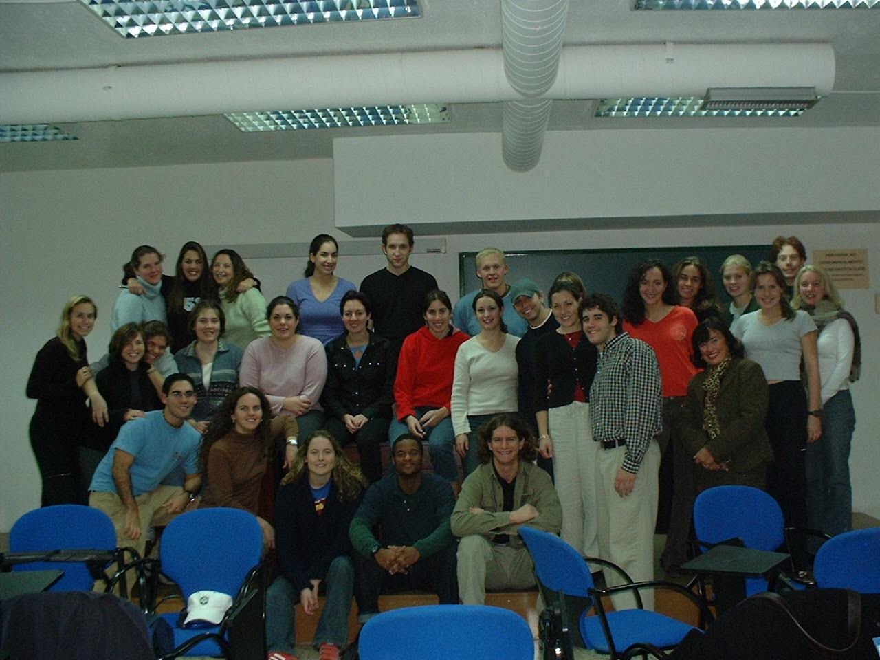 Malaga Program Director Grace Jarvis poses for a photo with students in the Malaga center