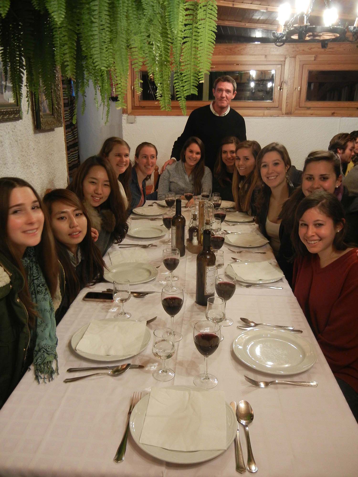Málaga Director Jorge Sagastume with students at dinner