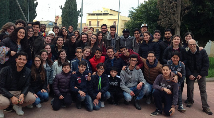 Students in the Mediterranean Migration Mosaic pose with immigrants they met and interviewed in Mazara Del Vallo, Italy.