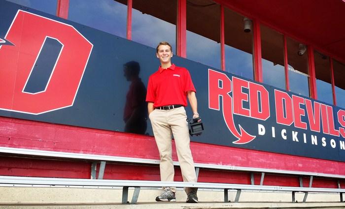 CHristian Payne poses outside the broadcast booth at Biddle Field.