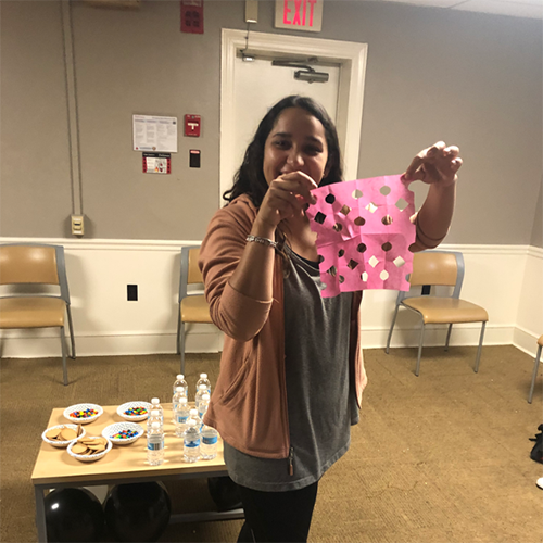 Spanish Students from Dickinson's Romance Language House holding up a traditional craft