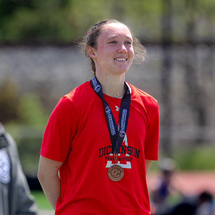 A Dickinson Athlete receives a championship medal