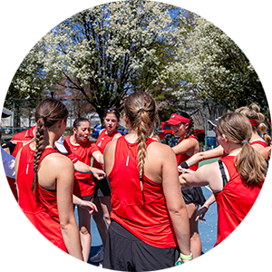 Dickinson Women's Tennis team putting their hands in during a team huddle