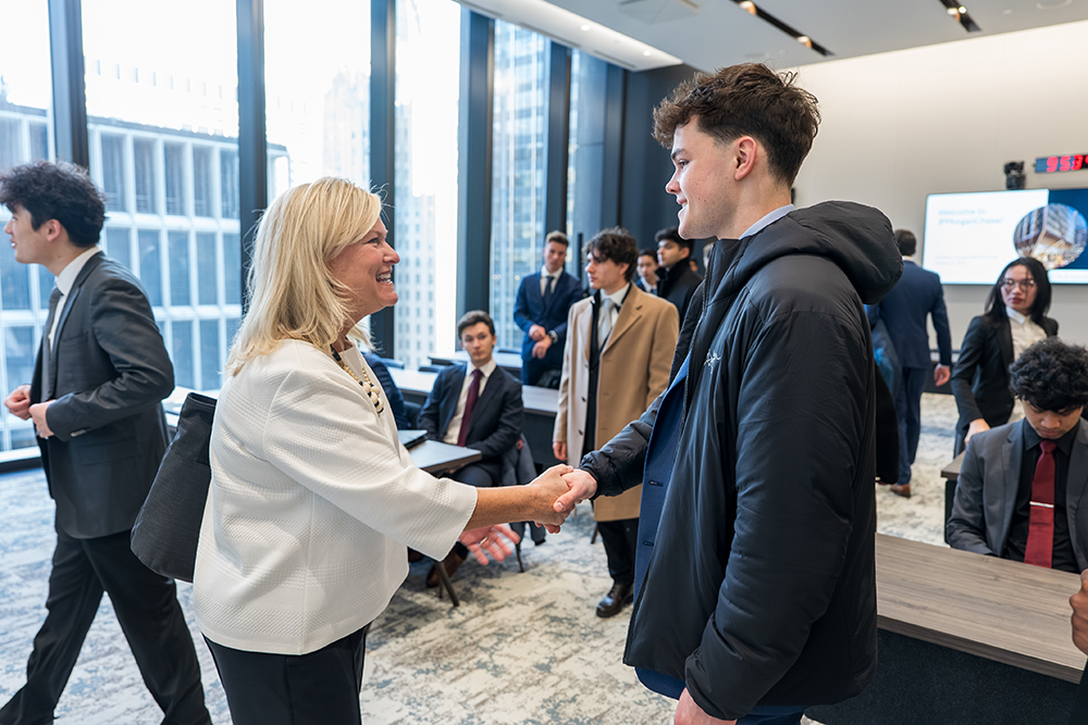 Two individuals shake hands at the NYC Career Trek at JP Morgan Chase