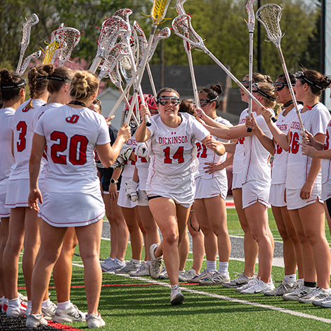 Dickinson Women's lacross team running onto the field