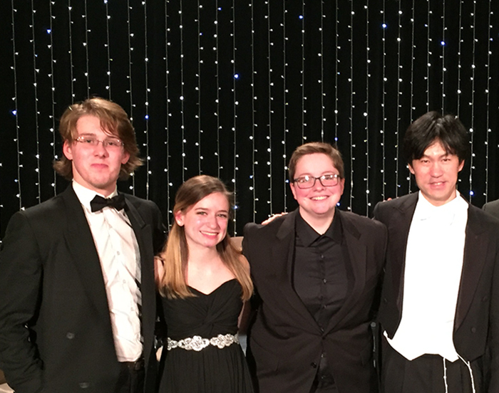 From left: Isaac Ward ’18, Anna Ferry ’19, Morgan Bates ’18 and Cheung Chau, director of Sinfonietta Polonia.