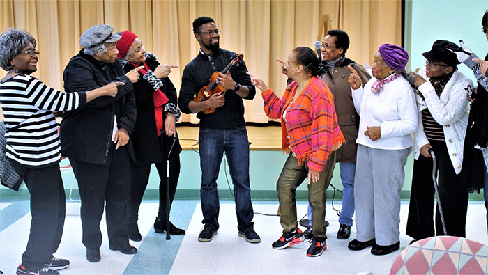 Alexander Strachan '13 poses with a few audience members. “I like this photo, because it reflects the fun we had during the concert,” he says. “I played familiar music, and the seniors sang along and clapped their hands.