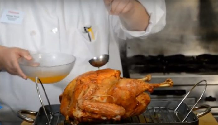 Catering Chef Ashley Telep bastes a perfectly roasted Thanksgiving turkey.