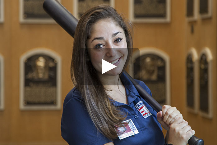 Erica Wells '19 poses with memorabilia during her summer internship at the National Baseball Hall of Fame and Museum.