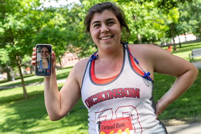 Olivia Termini '19 co-developed a virtual 5K with classmate Taylor Bednar (shown on Termini's phone screen). Photo by Carl Socolow '77.