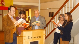 A student, faculty, and staff read together in four different languages